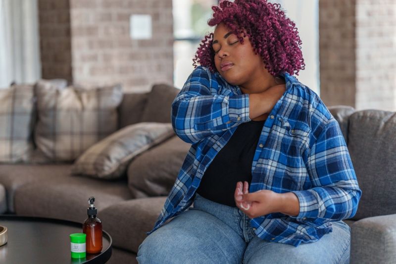 A person applies a cannabis topical to their shoulder at home.